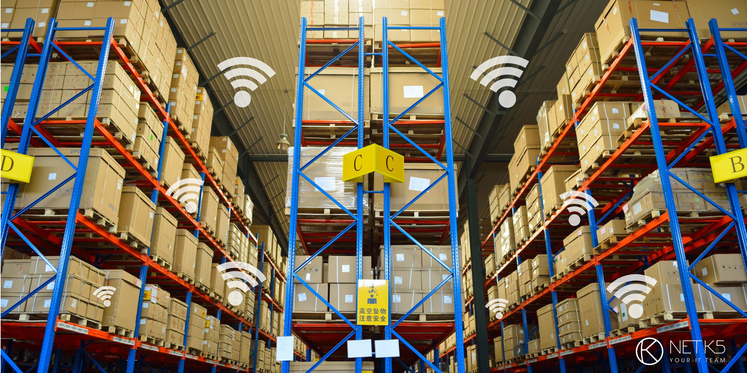 Large warehouse with tall shelves stacked with cardboard boxes; several Wi-Fi signal icons are overlaid, suggesting wireless connectivity throughout the space.